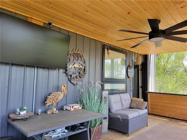 sunroom with a ceiling fan