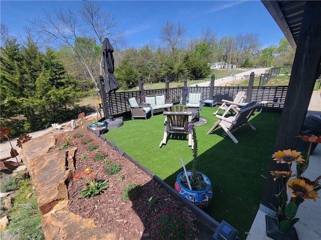 view of yard with fence and an outdoor living space