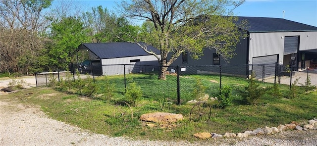 view of yard featuring fence and a garage