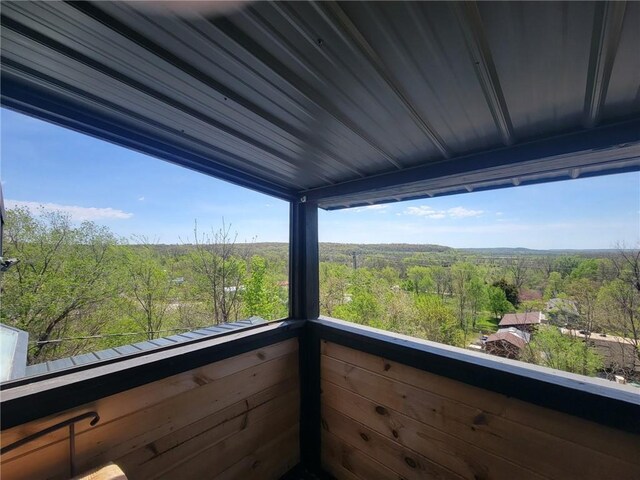 balcony featuring a forest view