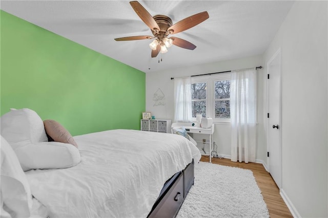 bedroom with light hardwood / wood-style flooring and ceiling fan