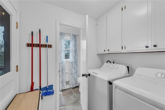 laundry room featuring cabinets and separate washer and dryer