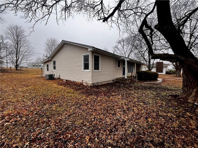 view of side of home with central air condition unit