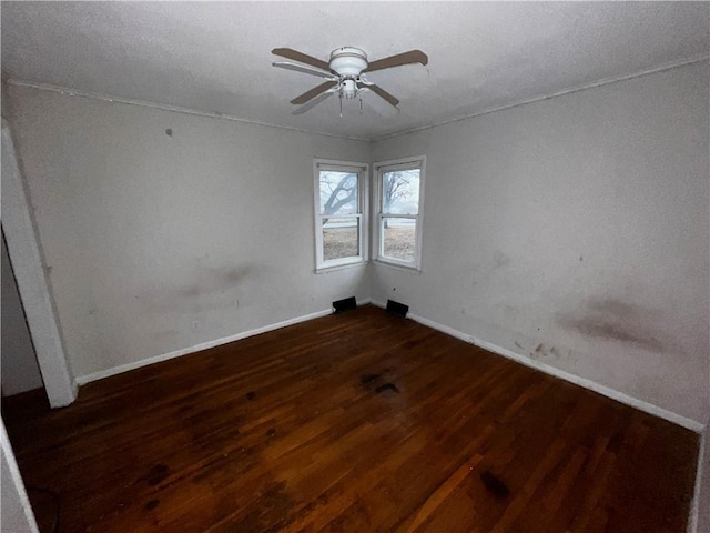 empty room featuring ceiling fan and dark hardwood / wood-style floors