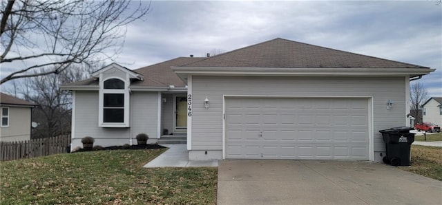 ranch-style house featuring a garage and a front yard