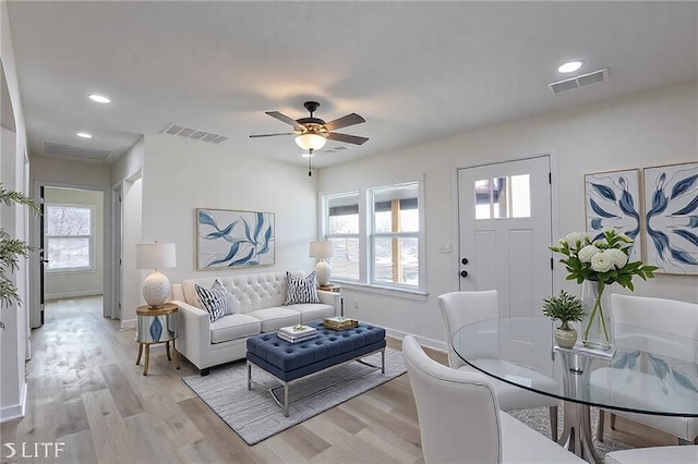 living room with a healthy amount of sunlight, light wood-type flooring, and visible vents