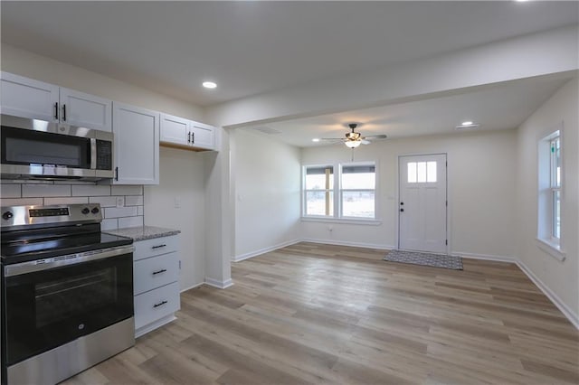 kitchen featuring recessed lighting, baseboards, appliances with stainless steel finishes, light wood-type flooring, and decorative backsplash