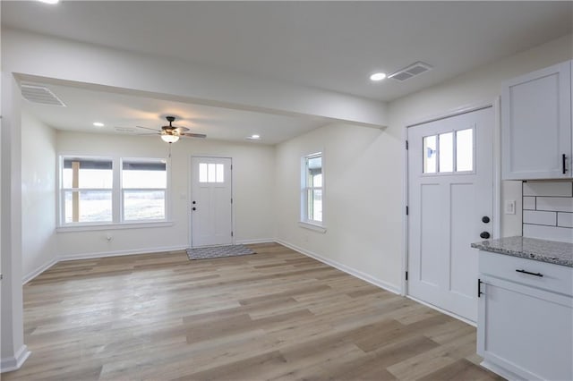 foyer featuring recessed lighting, light wood-type flooring, visible vents, and baseboards