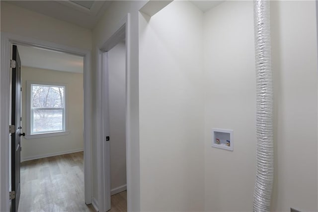 clothes washing area with laundry area, light wood-type flooring, hookup for a washing machine, and baseboards