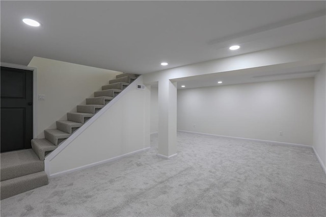 finished below grade area with carpet, stairs, baseboards, and recessed lighting