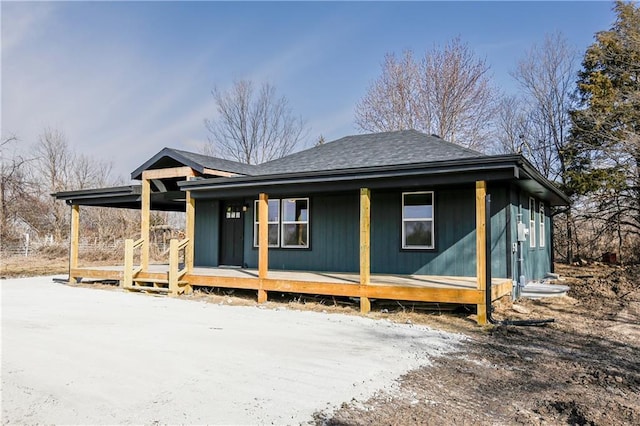 view of front of property featuring a porch and roof with shingles