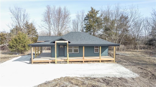 view of front facade featuring driveway and roof with shingles