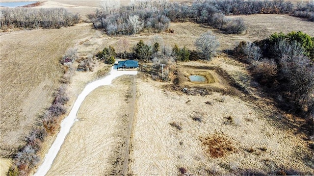 birds eye view of property with a rural view