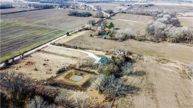 birds eye view of property with a rural view