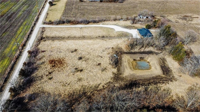 birds eye view of property with a rural view