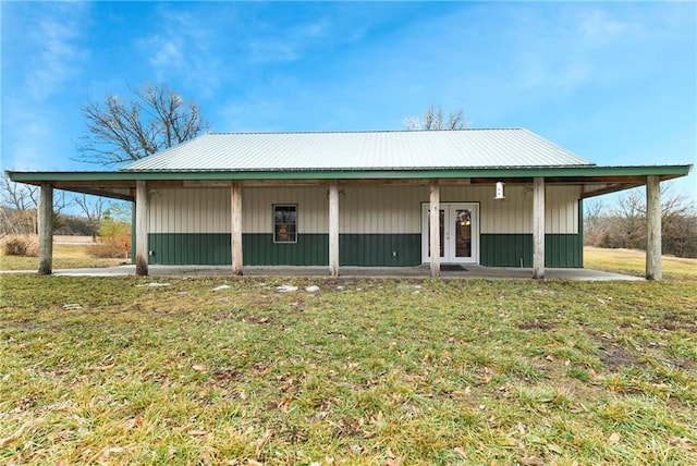 view of front facade with french doors and a front lawn