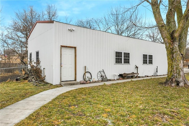 view of outbuilding featuring a lawn