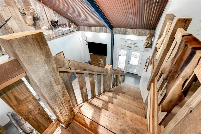 stairway featuring wood-type flooring and french doors