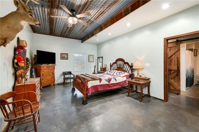 bedroom featuring a barn door and ceiling fan