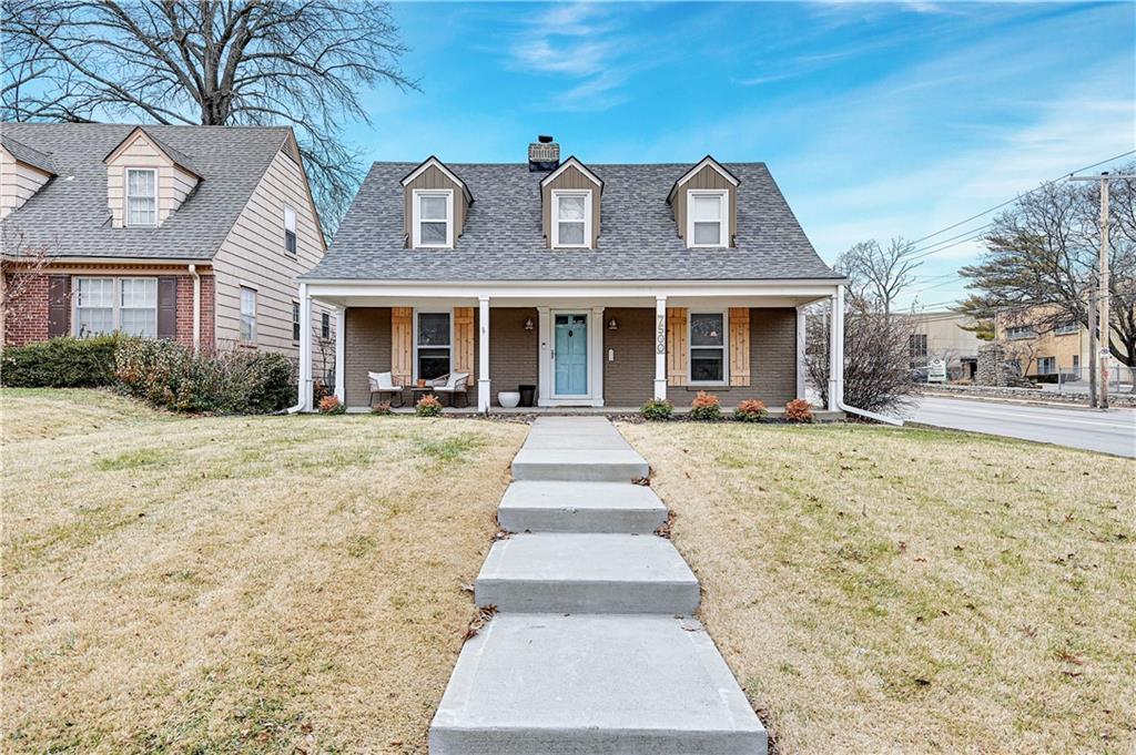 cape cod home featuring a front yard and a porch