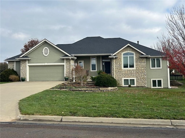 single story home with a shingled roof, a garage, stone siding, driveway, and a front lawn