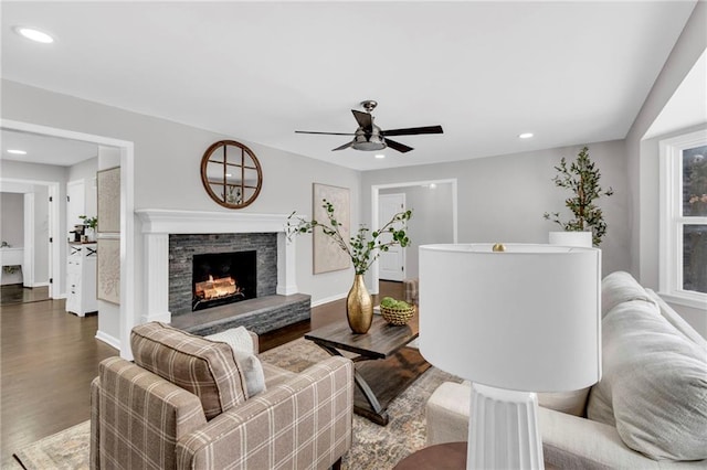 living room with a fireplace, wood finished floors, and recessed lighting