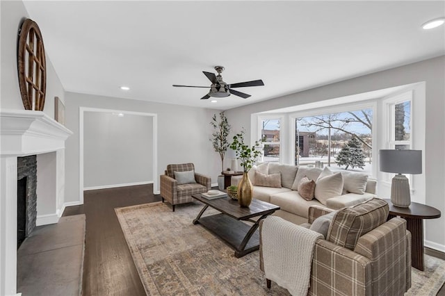 living room with a fireplace, recessed lighting, a ceiling fan, wood finished floors, and baseboards