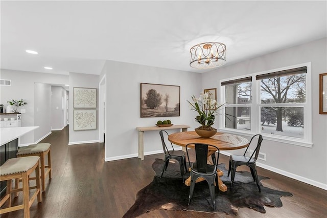 dining room featuring dark wood-style flooring, recessed lighting, an inviting chandelier, and baseboards