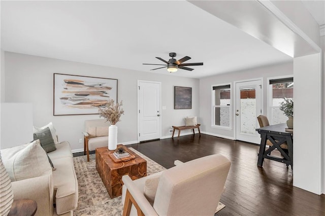 living area with ceiling fan, baseboards, and wood finished floors