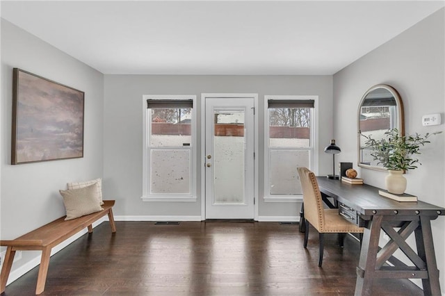 home office with baseboards and wood finished floors