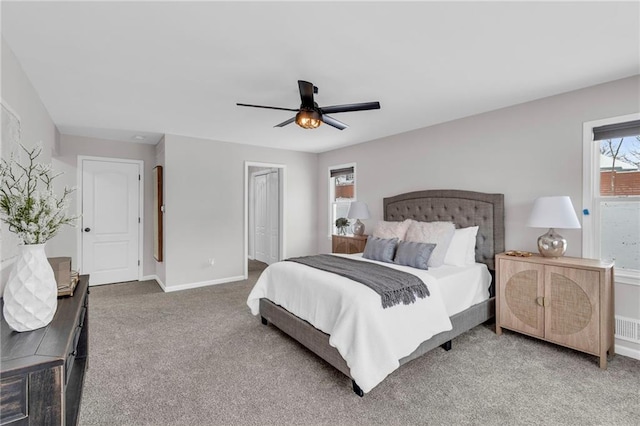 carpeted bedroom featuring baseboards and a ceiling fan