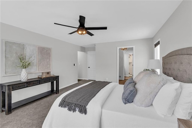 carpeted bedroom featuring ceiling fan, connected bathroom, and baseboards