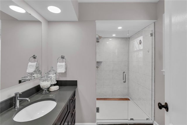 bathroom featuring a shower stall and vanity