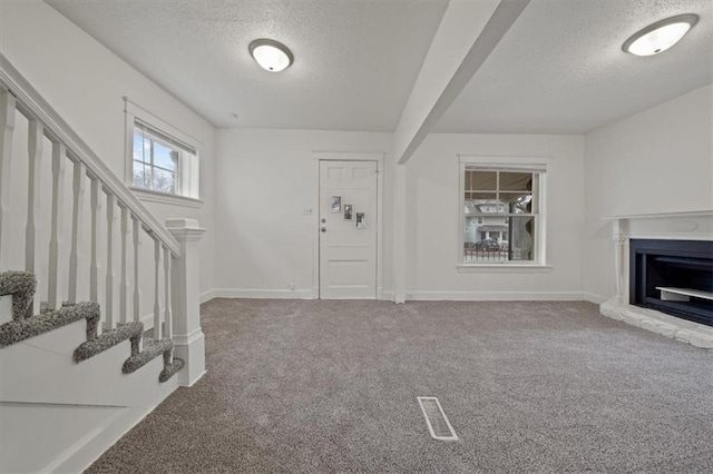 living room featuring a textured ceiling and carpet