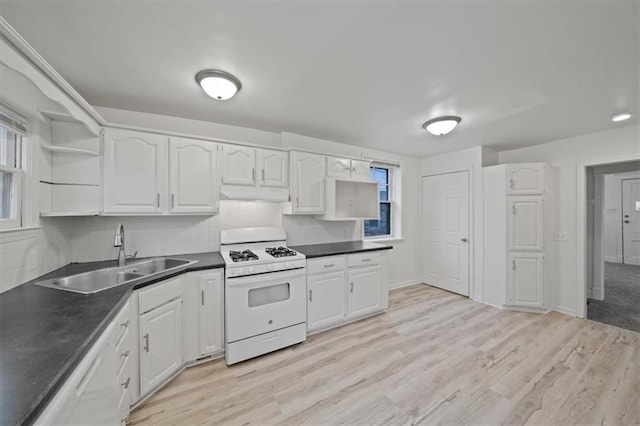 kitchen featuring white cabinetry, sink, white appliances, and light wood-type flooring