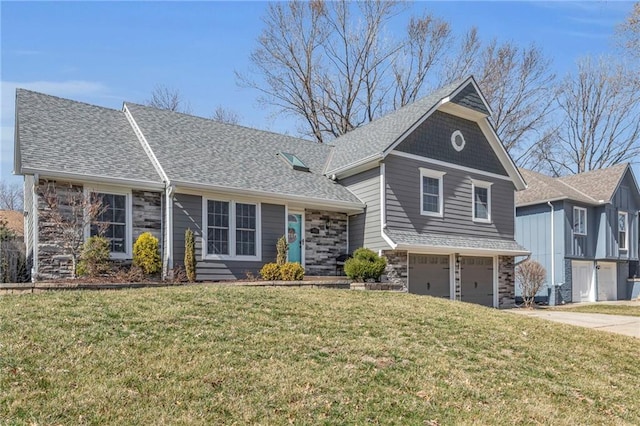 view of front of property featuring driveway, a front lawn, stone siding, roof with shingles, and an attached garage