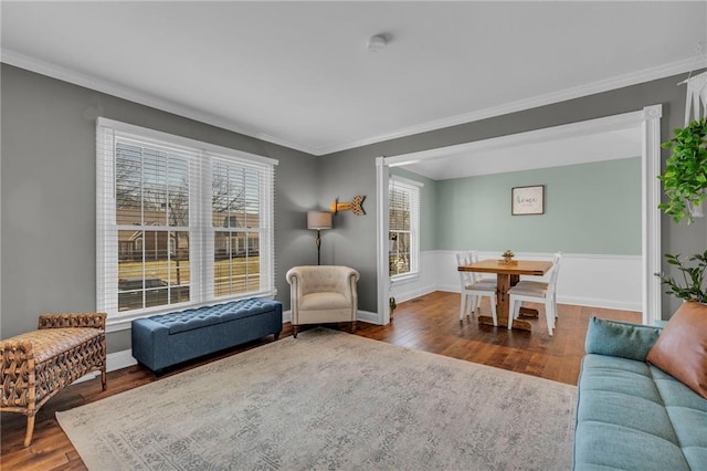 interior space with baseboards, wood finished floors, and crown molding