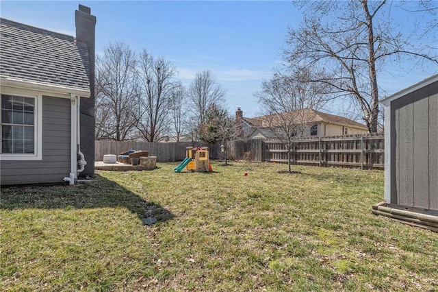 view of yard featuring a playground and a fenced backyard