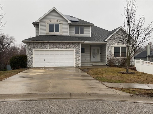 view of front of house featuring a garage and solar panels