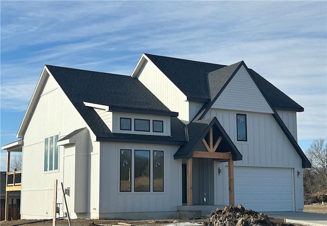 modern farmhouse style home featuring an attached garage and roof with shingles