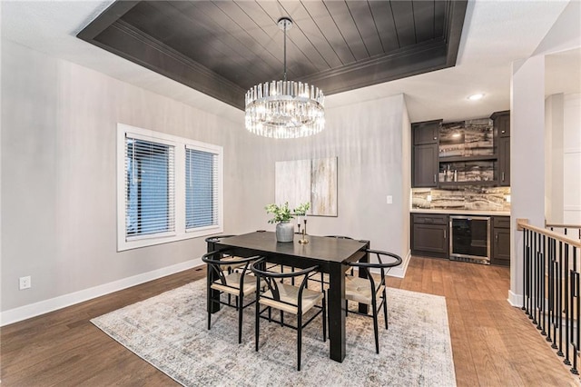 dining area featuring wine cooler, wood ceiling, light hardwood / wood-style flooring, and a raised ceiling