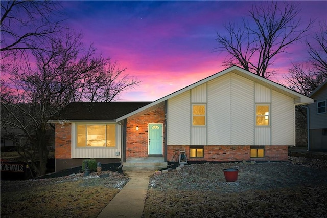 split level home featuring brick siding