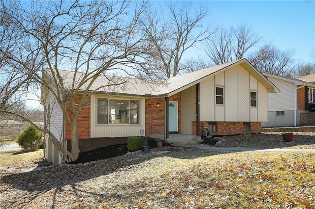 split level home featuring brick siding