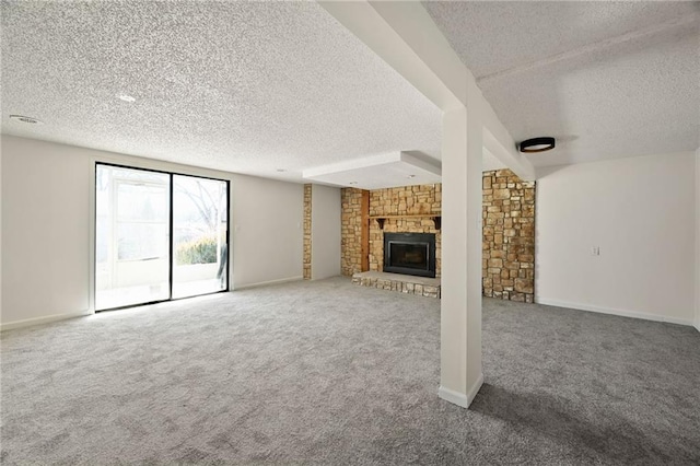 unfurnished living room featuring a large fireplace, a textured ceiling, and carpet