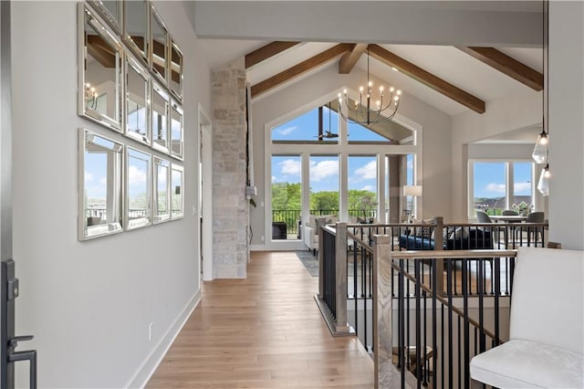 hall with an inviting chandelier, hardwood / wood-style flooring, beam ceiling, and high vaulted ceiling