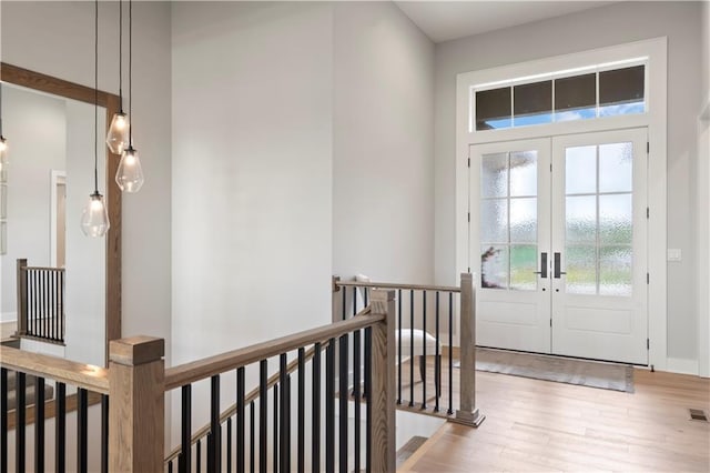 entryway featuring a wealth of natural light, light hardwood / wood-style floors, and french doors