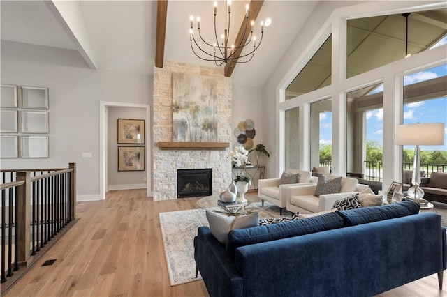 living room with beamed ceiling, a stone fireplace, high vaulted ceiling, and light wood-type flooring