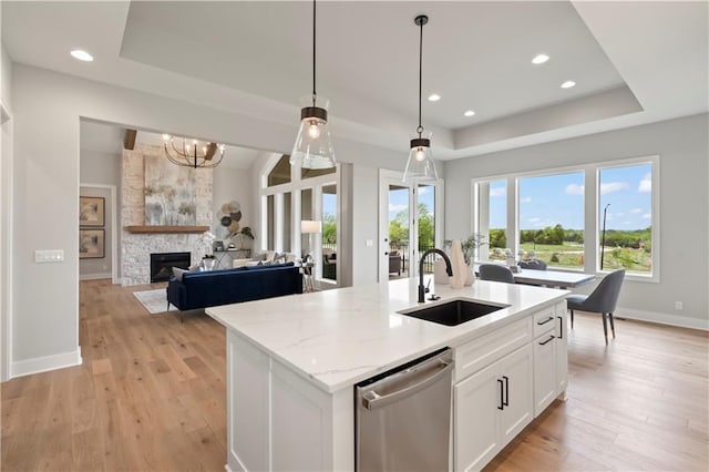 kitchen featuring white cabinetry, sink, a raised ceiling, and dishwasher