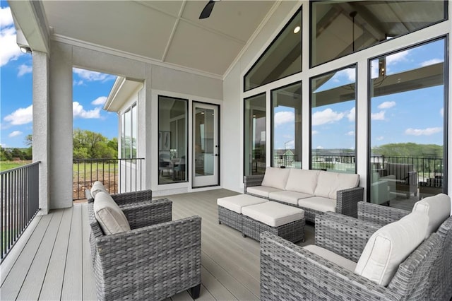 wooden deck featuring an outdoor living space and ceiling fan