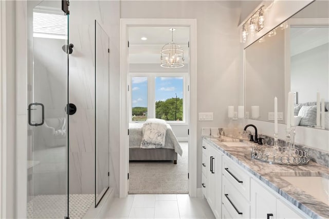 bathroom with a chandelier, vanity, an enclosed shower, and tile patterned flooring